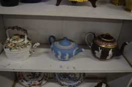 A Wedgwood pale blue Jasper ware teapot and two other teapots.