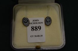 A pair of 9ct gold and enamel ear studs depicting flowers.