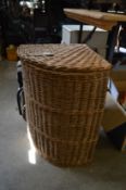 A wicker corner laundry basket.