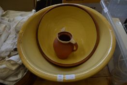 Two large slip glazed terracotta bowls and a similar jug.