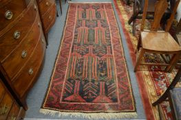 A Persian design long rug, blue ground with stylised decoration, 285cm x 105cm.