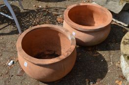 A pair of terracotta planters.