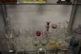 A shelf of decorative and household glassware.