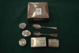 A silver cigarette box and other items.