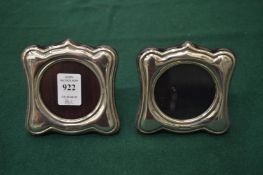 A pair of silver photograph frames.