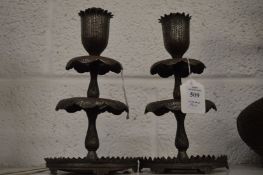 A good pair of Islamic tinned copper candlesticks with chased decoration.