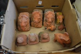 Terracotta plant pot stands and other items.