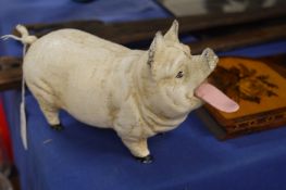 A cast iron pig with articulated tongue.