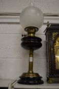 Victorian oil lamp with amethyst glass reservoir.