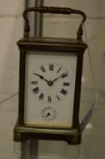A brass carriage clock with alarm.