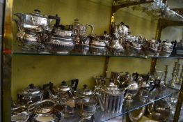 A large collection of silver plated teapots, coffee pots, sugar bowls and milk jugs.