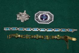 A group of bijouterie to include a decorative brooch.