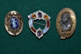 A group of three brooches to include a Scottish hard stone brooch and another inset with enamel.