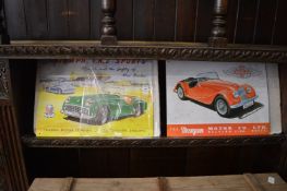 Two reproduction tin plate car advertising signs.
