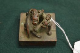 A small Chinese bronze square shaped seal.