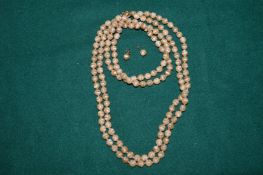 A hard stone bead necklace and a pair of matching ear studs.