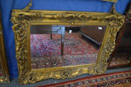 A large decorative gilt framed mirror.