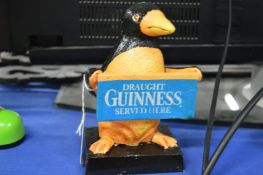 A small cast iron novelty Guinness penguin.