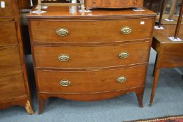 A 19th century mahogany bow front three drawer chest.