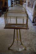 A brass and mahogany revolving magazine rack.