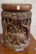 An African carved hardwood stool depicting elephants amongst trees.