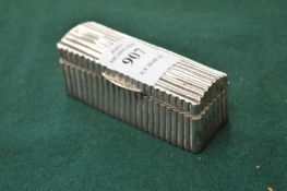 A silver snuff box with ribbed decoration.