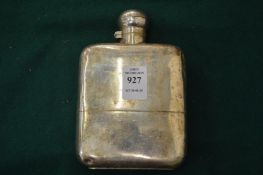 A silver hip flask with captive top and detachable base.