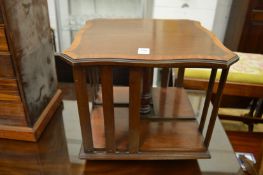 A table top satinwood cross banded mahogany revolving bookcase.