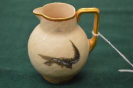 A small porcelain milk jug decorated with birds.