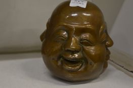 A bronze four face Buddha paperweight.