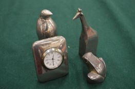 Three Dansk design silver plated paperweights and a miniature clock paperweight.
