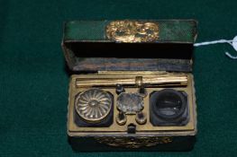 A 19th century shagreen and ormolu mounted miniature casket shaped writing set.