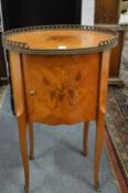 A French inlaid king wood oval shaped bedside cupboard.