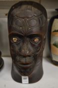 A New Zealand, Aboriginal carved wood mask of a man with abalone eyes.