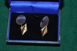 A pair of 9ct gold and diamond set cufflinks.