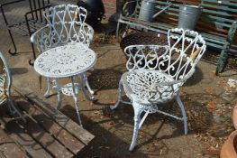 A white painted aluminium three piece patio set comprising pair of armchairs and small table.