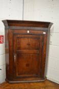 A Georgian oak hanging corner cupboard.