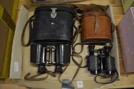 A pair of Carl Zeiss binoculars with leather case and another pair with a case.