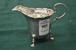 A small silver cream jug.