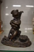 A good small cast bronze figure of a young boy harvesting grapes.