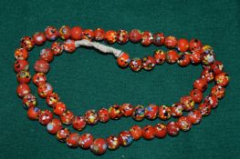 An enamelled glass bead necklace.