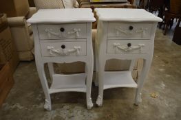 A pair of French style white painted two drawer bedside tables.