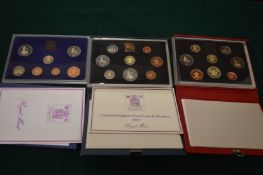 Three cased sets of proof coins.