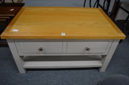 A modern oak and painted two drawer, two-tier coffee table.