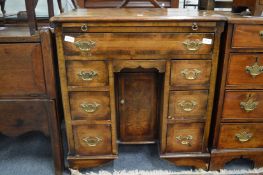 A George II design walnut kneehole dressing table/desk, the pull-out brushing slide operating a rise