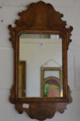 A small walnut fretwork framed mirror.