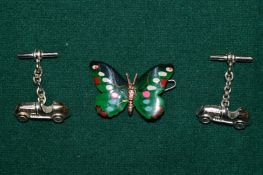 A pair of silver car shaped cufflinks and an enamel butterfly brooch.
