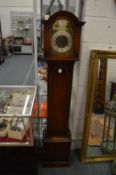 A reproduction oak grandmother clock.