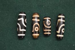 A group of four Zi beads.