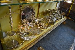 A large collection of plated items and pewter ware to include goblets, tankards, candelabra etc.